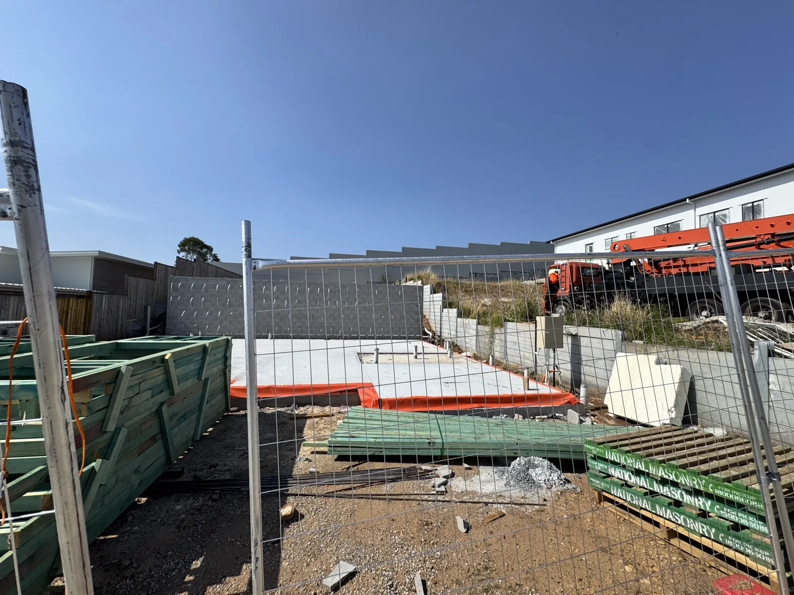 Blockwork retaining and boundary walls to a new residential slab on a sloping site, ahead of frame stage.